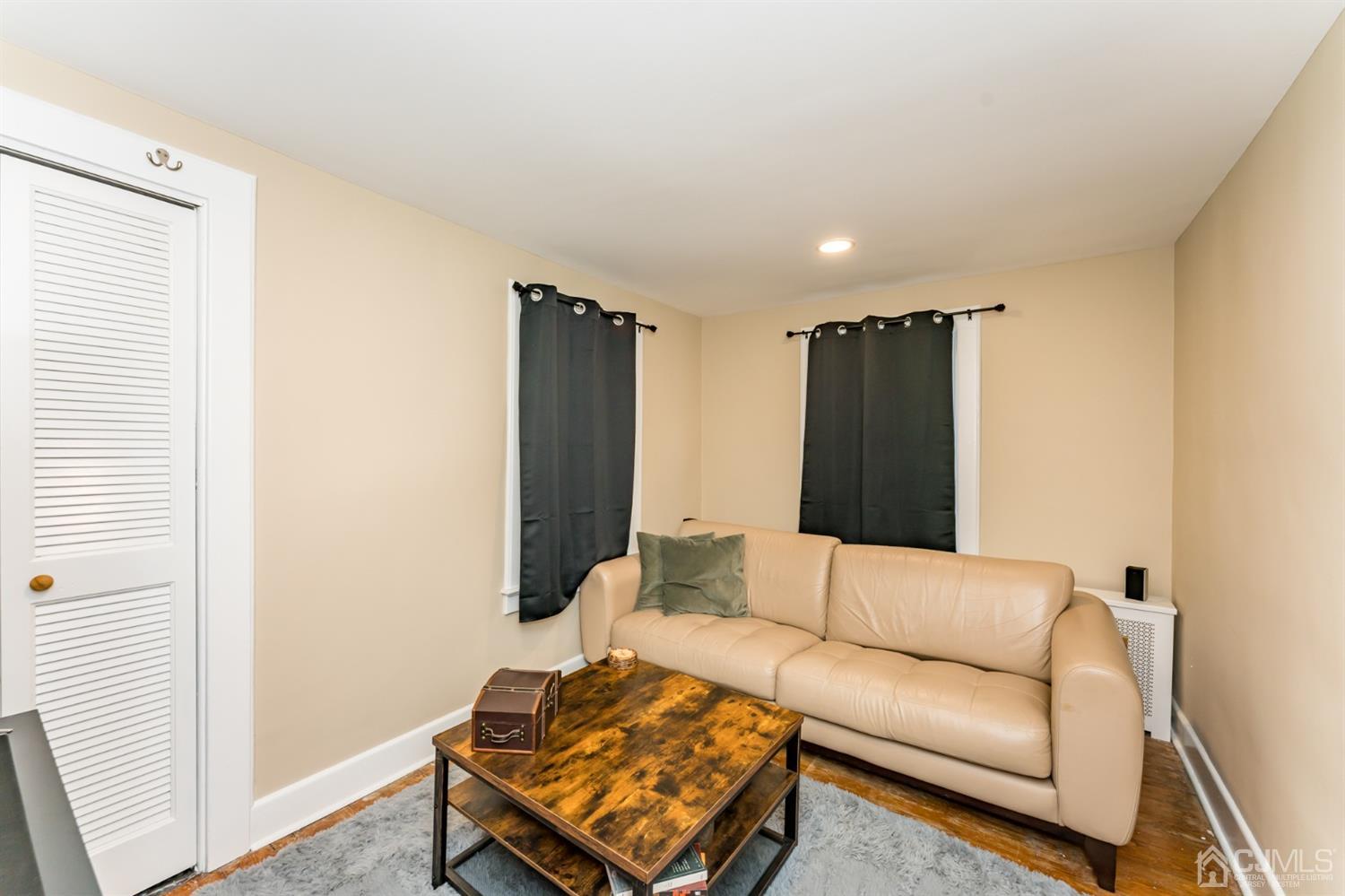 729 Livingston Road Elizabeth, NJ 07208 - Photo 15 of 26 a living room with furniture and a flat screen tv