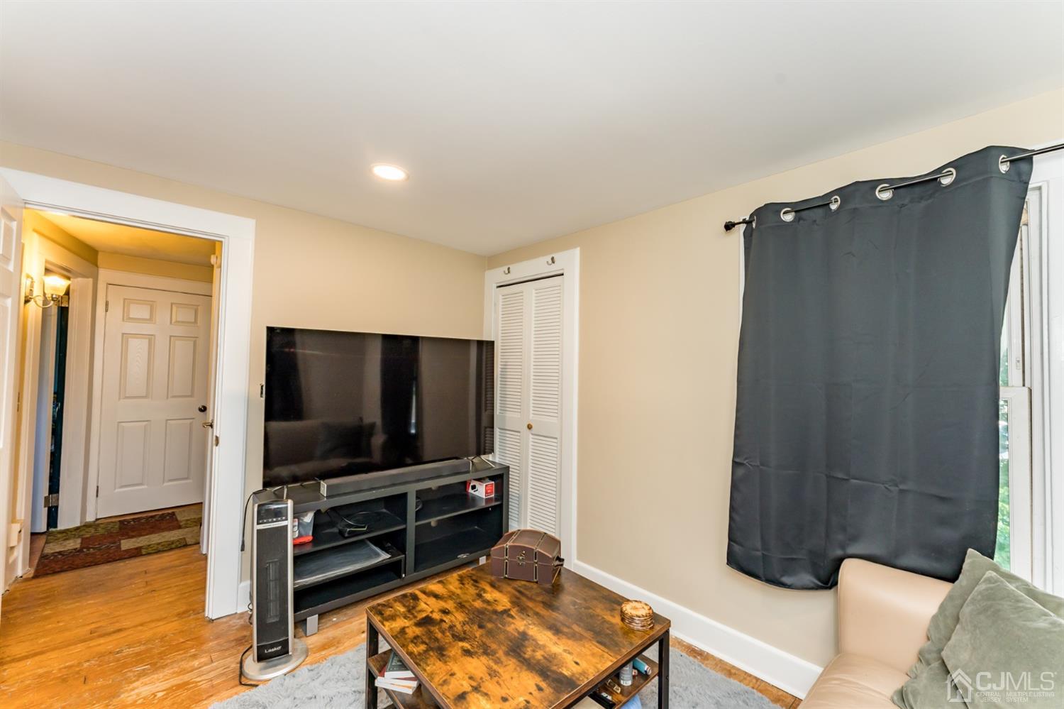 729 Livingston Road Elizabeth, NJ 07208 - Photo 16 of 26 a living room with furniture and a flat screen tv