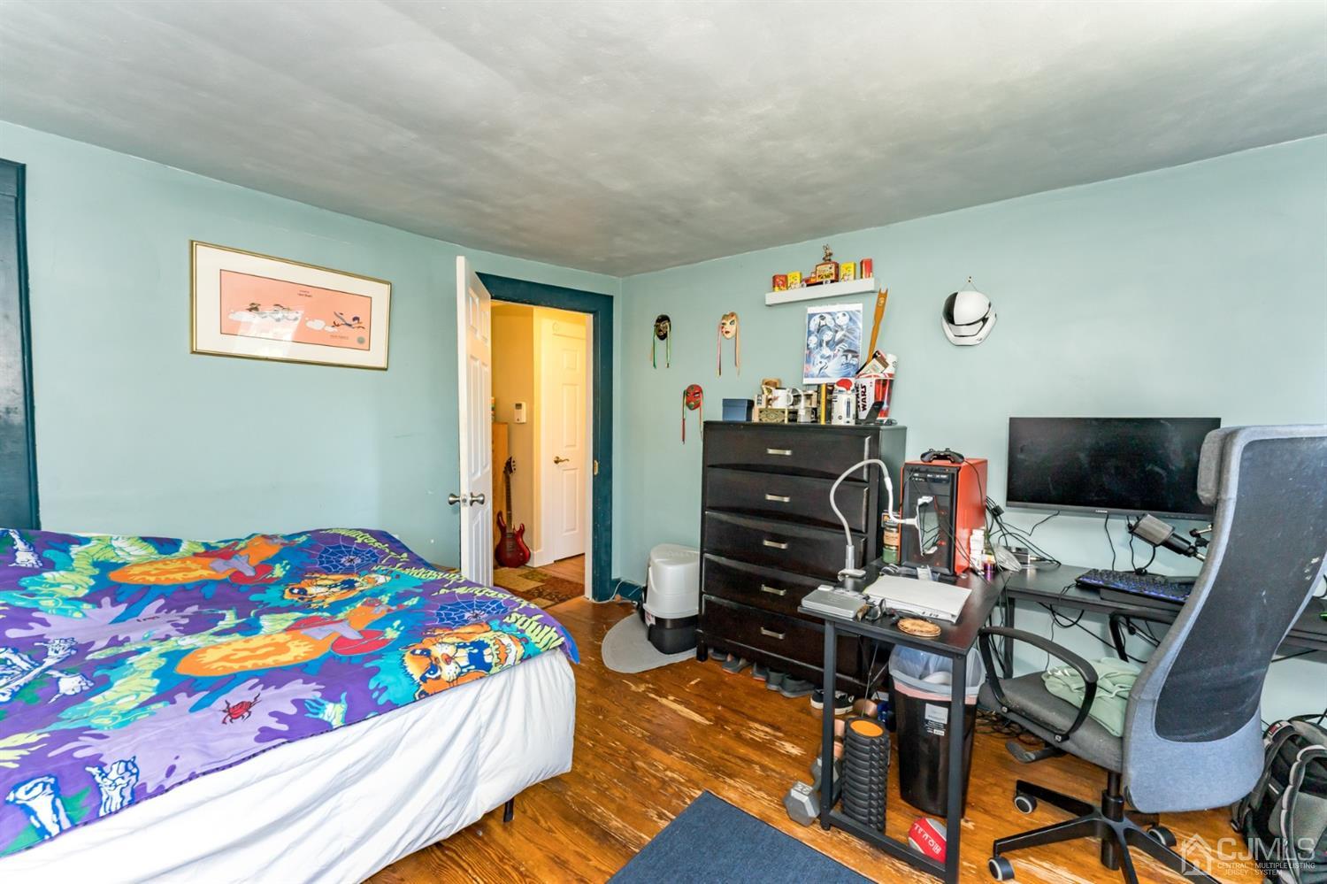 729 Livingston Road Elizabeth, NJ 07208 - Photo 18 of 26 a bedroom with a bed and a desk