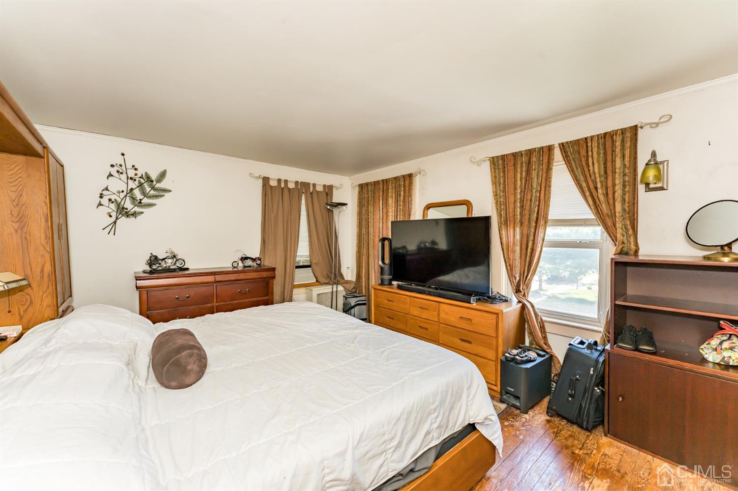 729 Livingston Road Elizabeth, NJ 07208 - Photo 19 of 26 a bedroom with a bed and flat screen tv