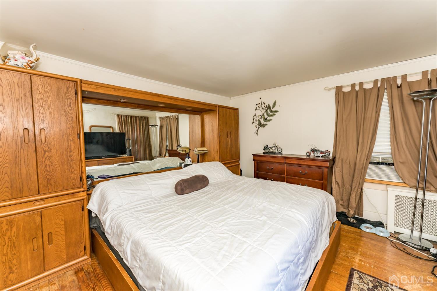 729 Livingston Road Elizabeth, NJ 07208 - Photo 20 of 26 a bedroom with a bed and a large window with outer view