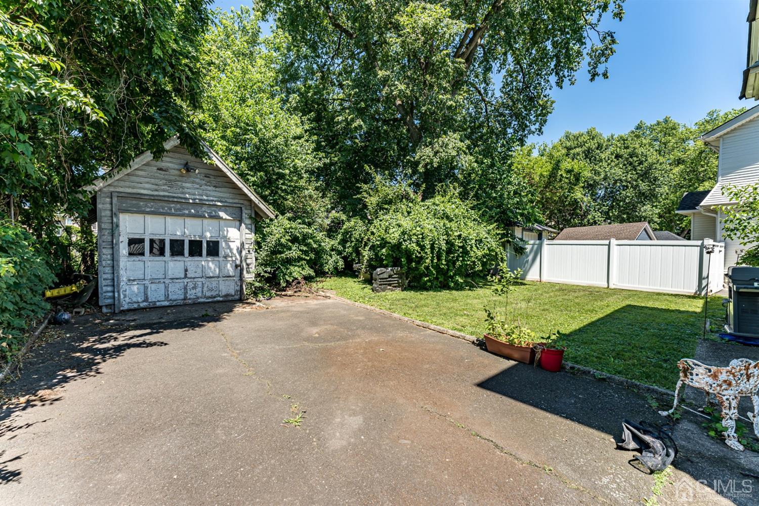 729 Livingston Road Elizabeth, NJ 07208 - Photo 23 of 26 a front view of a house with a yard and trees