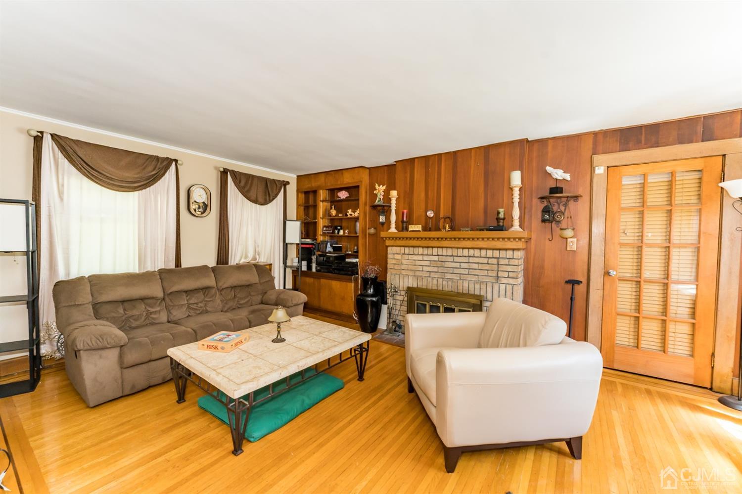 729 Livingston Road Elizabeth, NJ 07208 - Photo 5 of 26 a living room with furniture and a fireplace