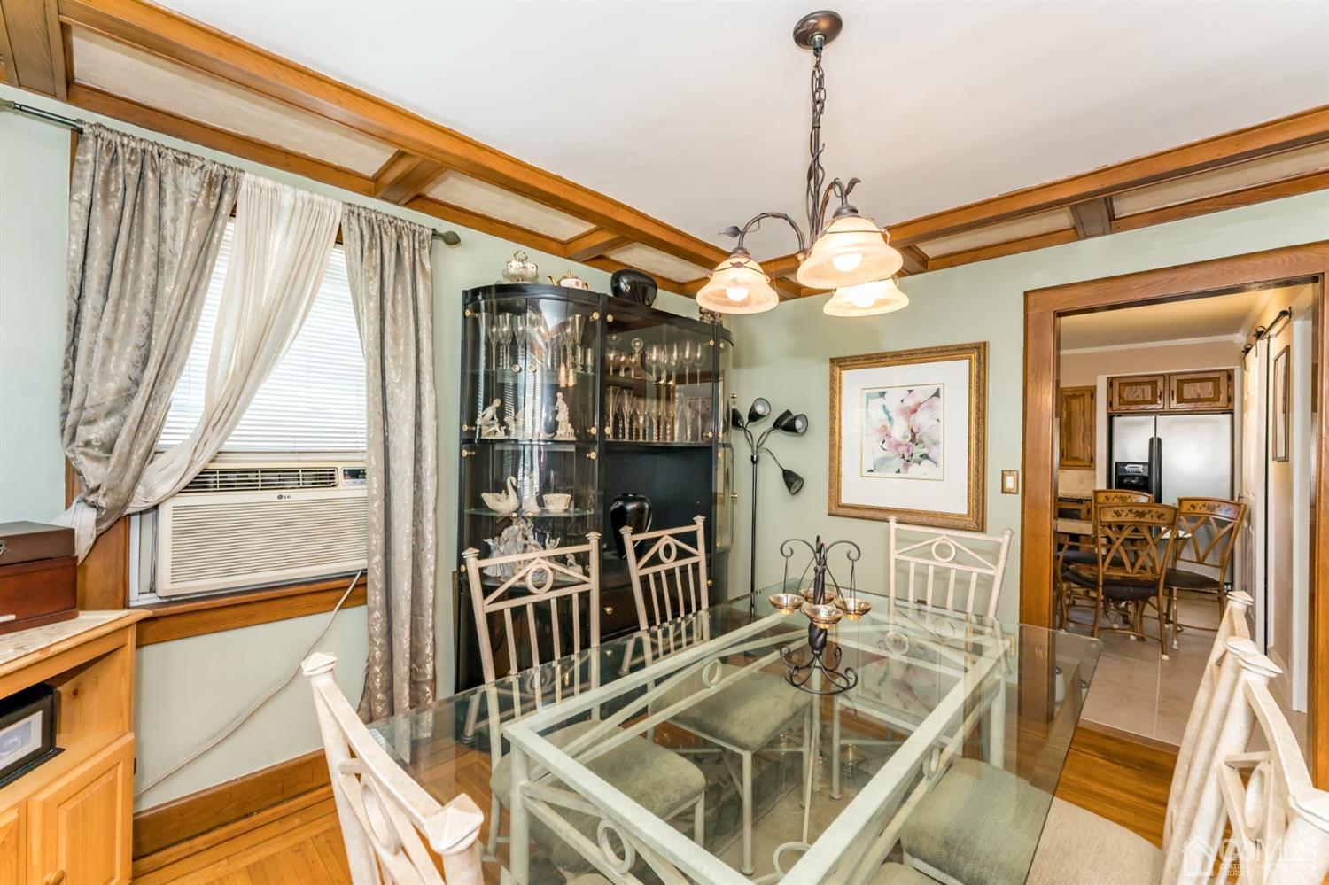 729 Livingston Road Elizabeth, NJ 07208 - Photo 8 of 26 a view of a dining room with furniture a chandelier and wooden floor