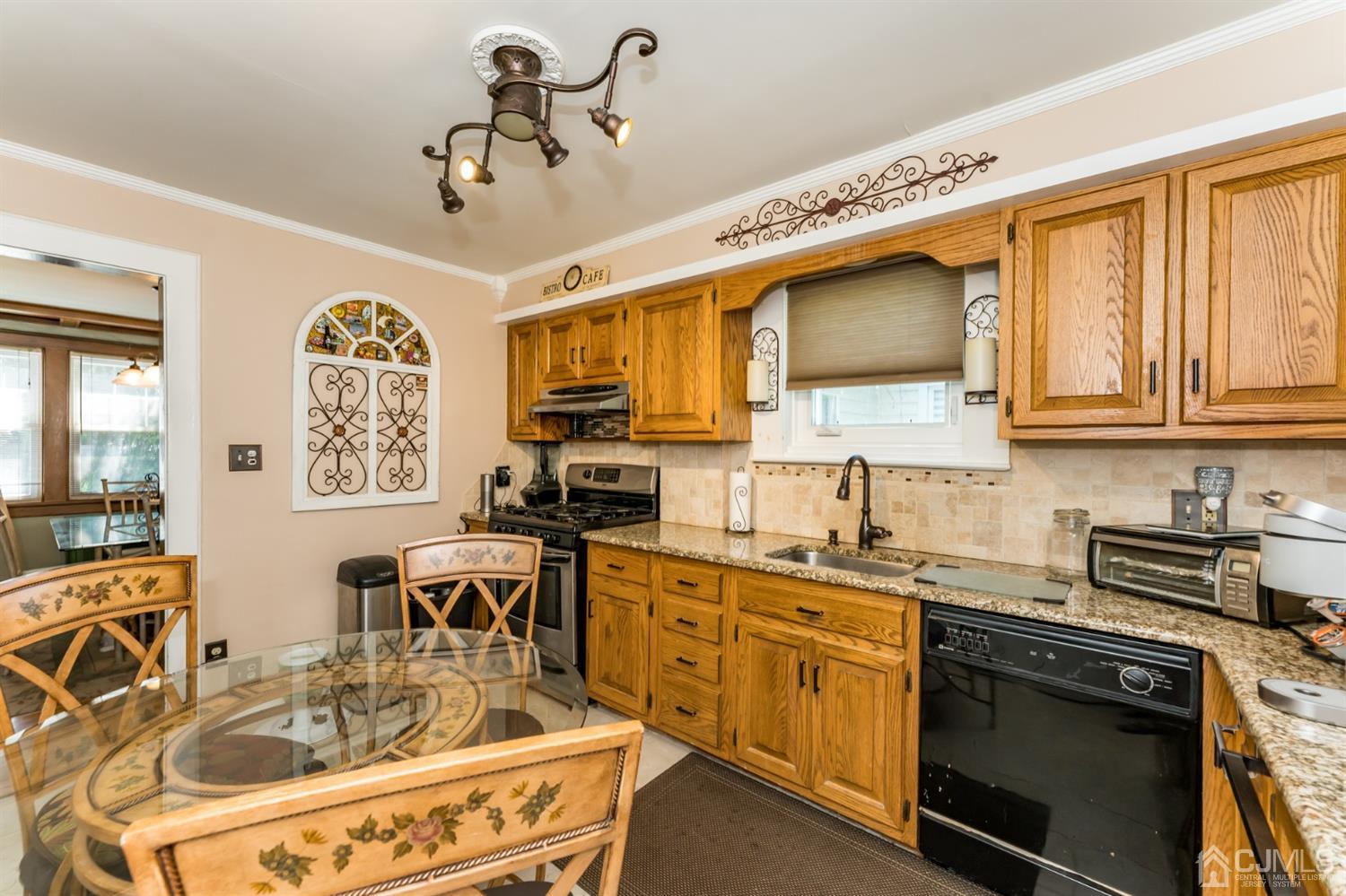729 Livingston Road Elizabeth, NJ 07208 - Photo 10 of 26 a kitchen with stainless steel appliances granite countertop a sink stove and cabinets