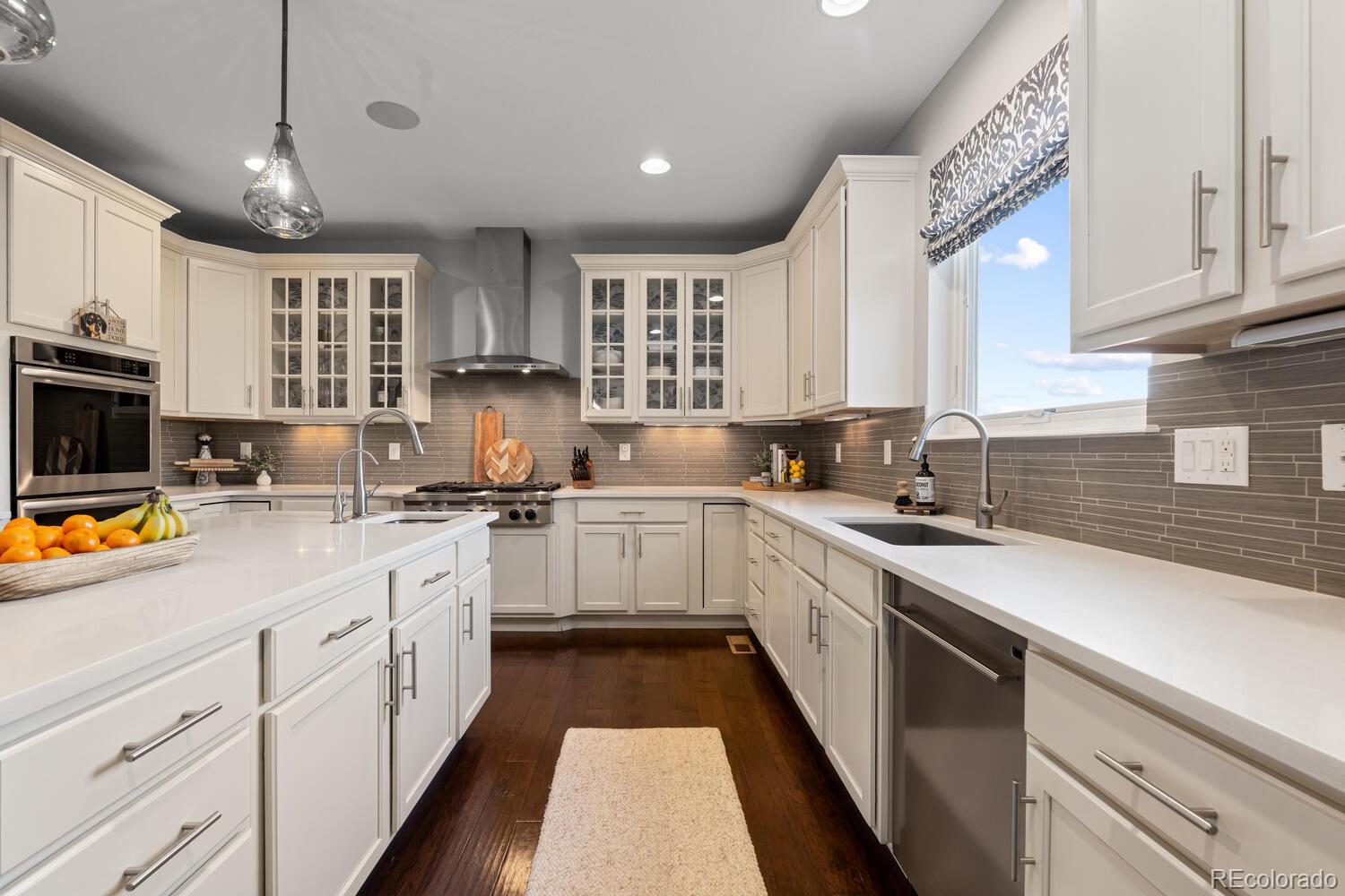 10800 Sundial Rim Road Highlands Ranch, CO 80126 - Photo 13 of 48 a kitchen with stainless steel appliances granite countertop a sink stove and cabinets