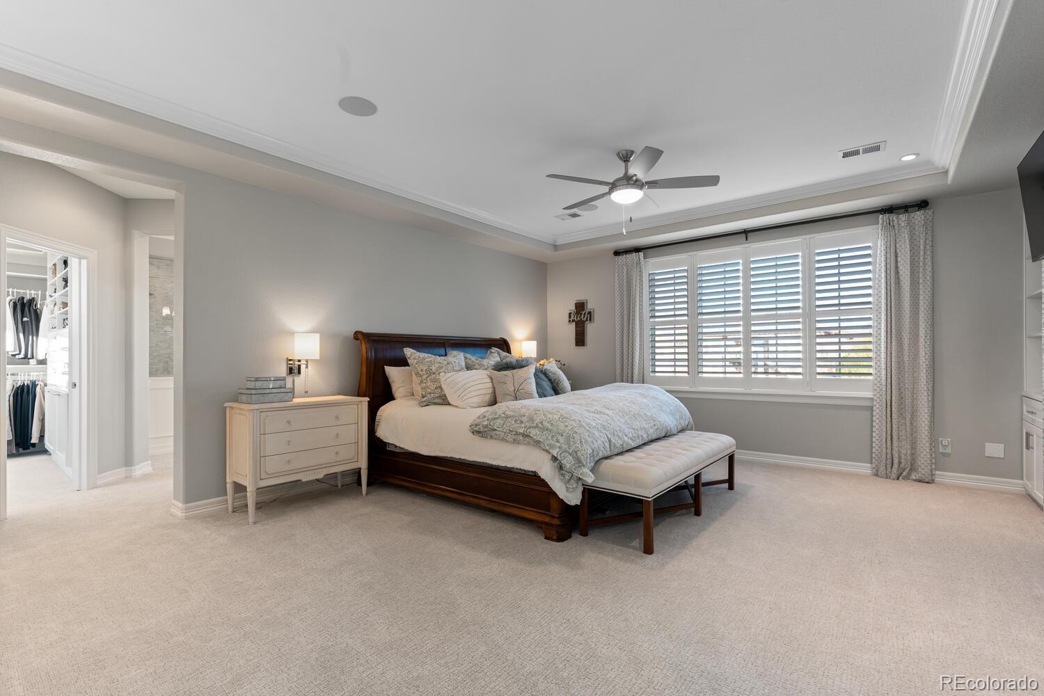 10800 Sundial Rim Road Highlands Ranch, CO 80126 - Photo 21 of 48 a spacious bedroom with a bed and a chandelier