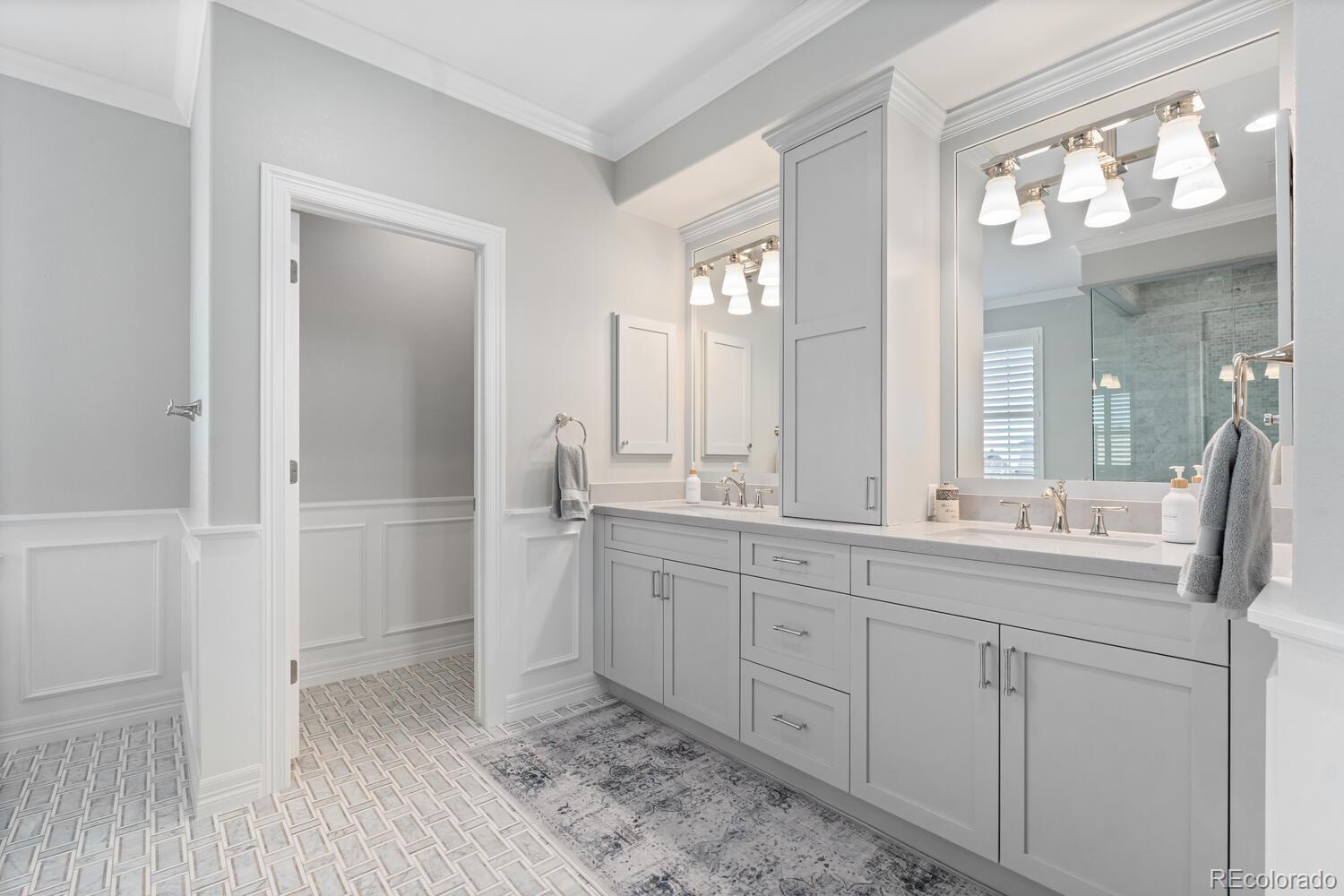10800 Sundial Rim Road Highlands Ranch, CO 80126 - Photo 25 of 48 a bathroom with a double vanity sink and a mirror