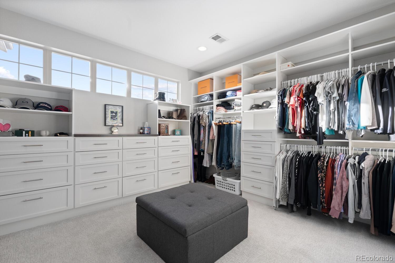 10800 Sundial Rim Road Highlands Ranch, CO 80126 - Photo 28 of 48 a view of walk in closet with clothes and shoes