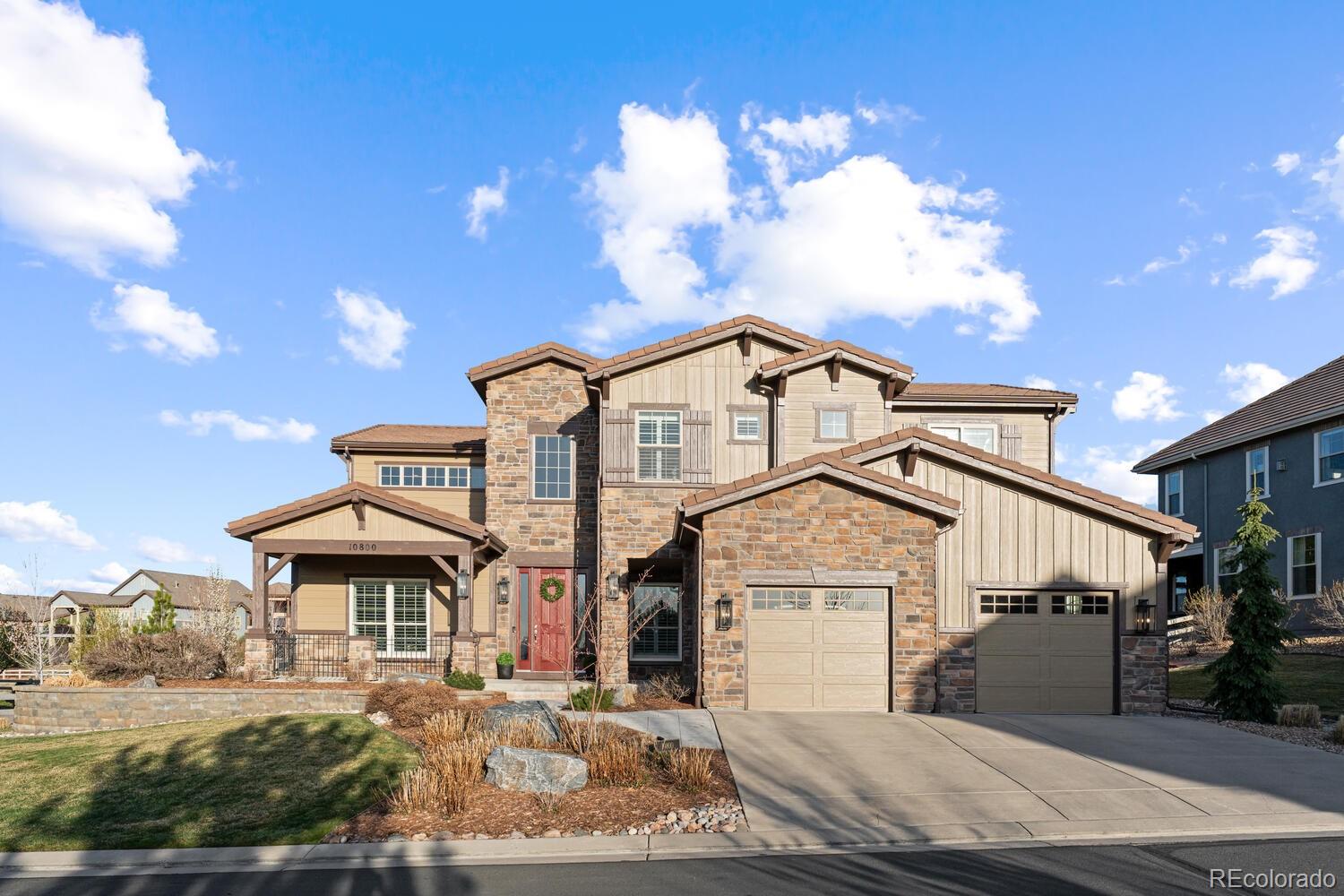 10800 Sundial Rim Road Highlands Ranch, CO 80126 - Photo 3 of 48 a front view of a house with a yard
