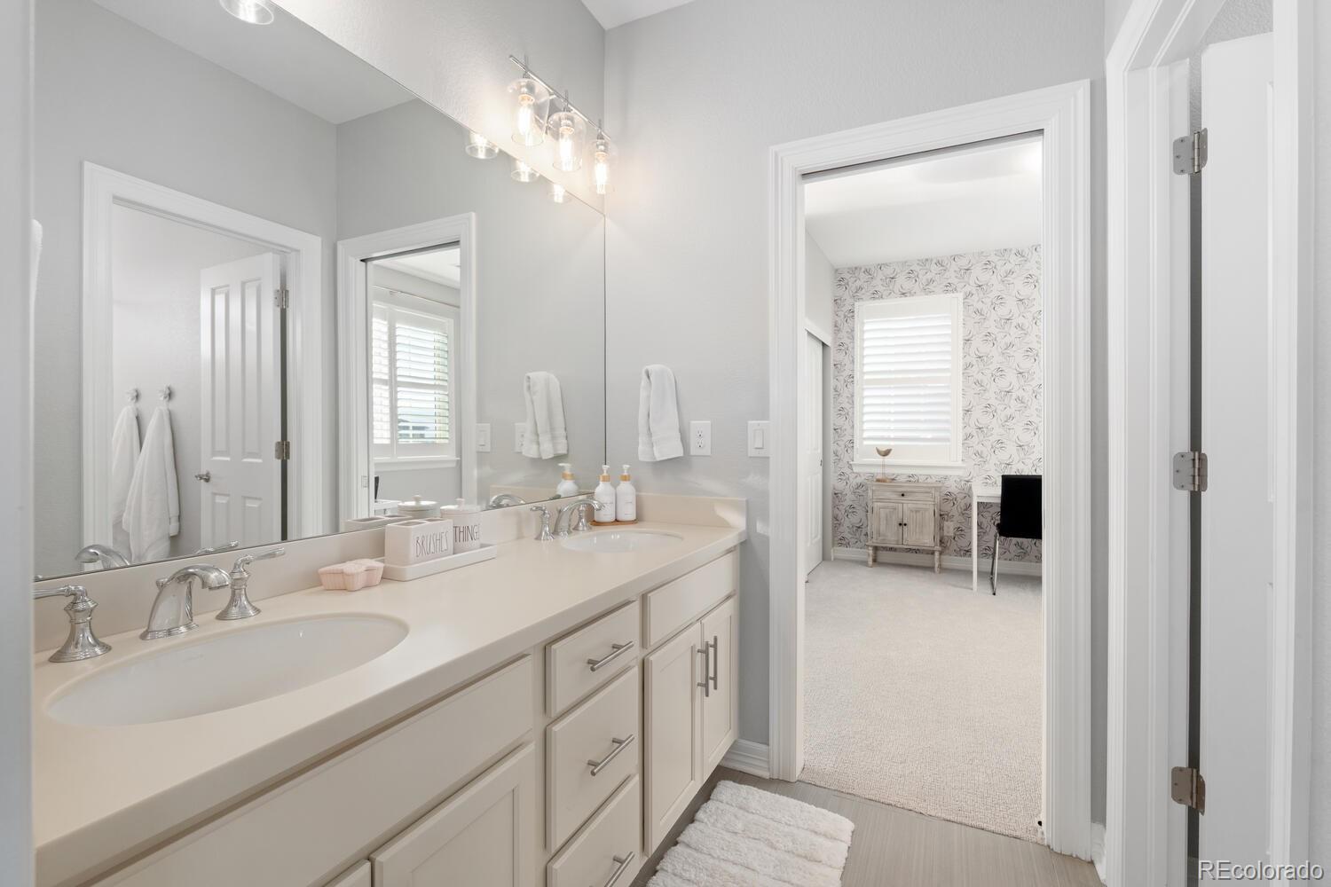 10800 Sundial Rim Road Highlands Ranch, CO 80126 - Photo 33 of 48 a bathroom with double vanity sinks and a mirror
