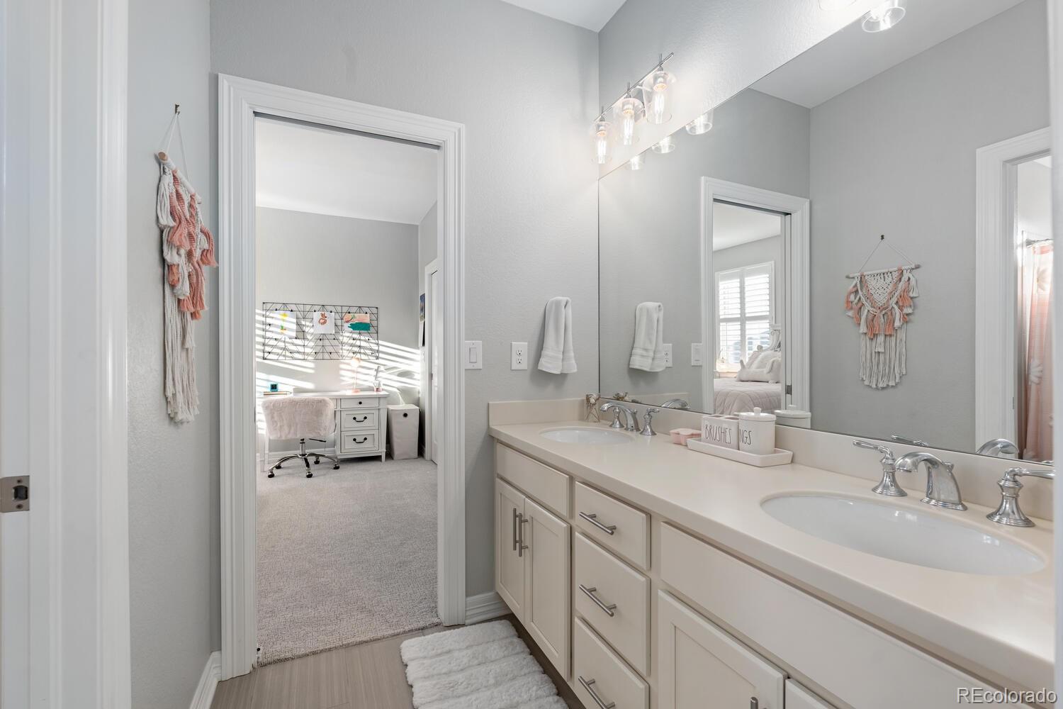 10800 Sundial Rim Road Highlands Ranch, CO 80126 - Photo 34 of 48 a en suite bathroom with 2 sink flowerpot and a mirror