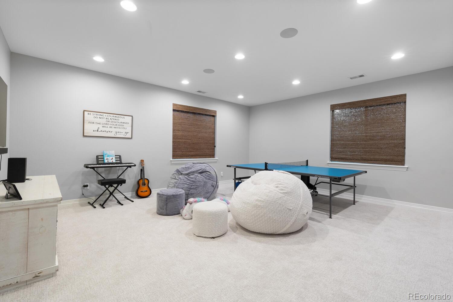 10800 Sundial Rim Road Highlands Ranch, CO 80126 - Photo 37 of 48 a living room with furniture a window and a flat screen tv