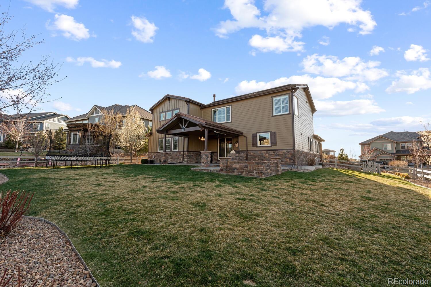 10800 Sundial Rim Road Highlands Ranch, CO 80126 - Photo 41 of 48 a front view of a house with a yard