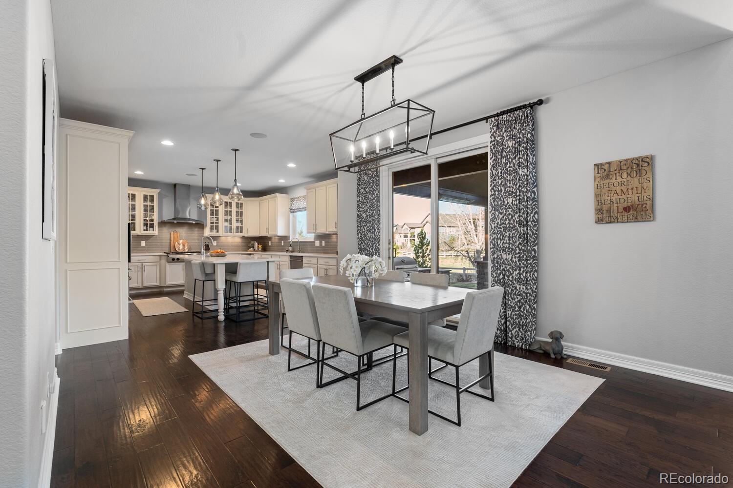10800 Sundial Rim Road Highlands Ranch, CO 80126 - Photo 10 of 48 a view of a dining room with furniture window and wooden floor