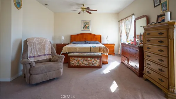 a bedroom with furniture and a dresser