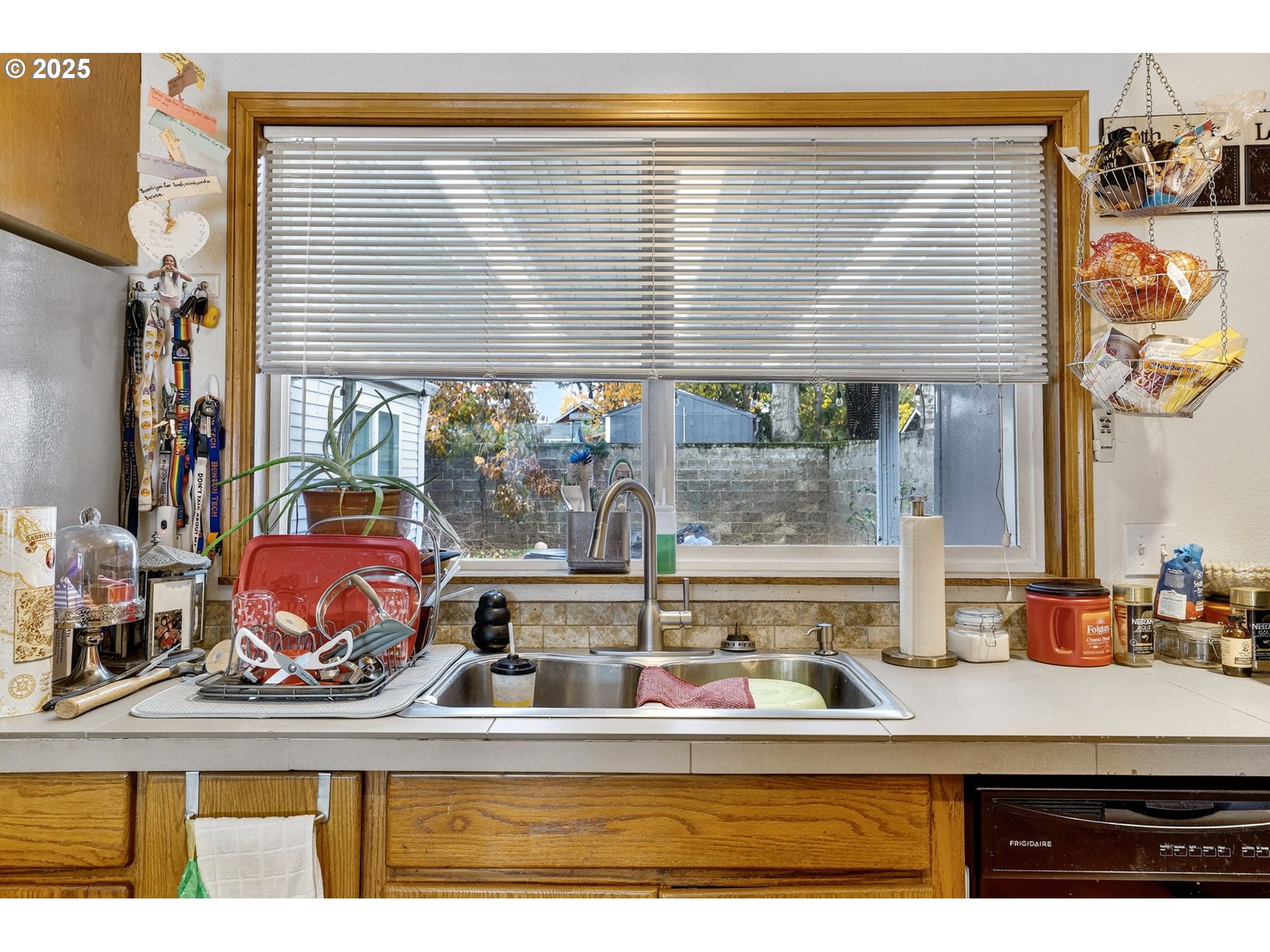 8739 Southeast Knapp Street Portland, OR 97266 - Photo 11 of 23 a view of a kitchen with kitchen island stainless steel appliances wooden floor and window