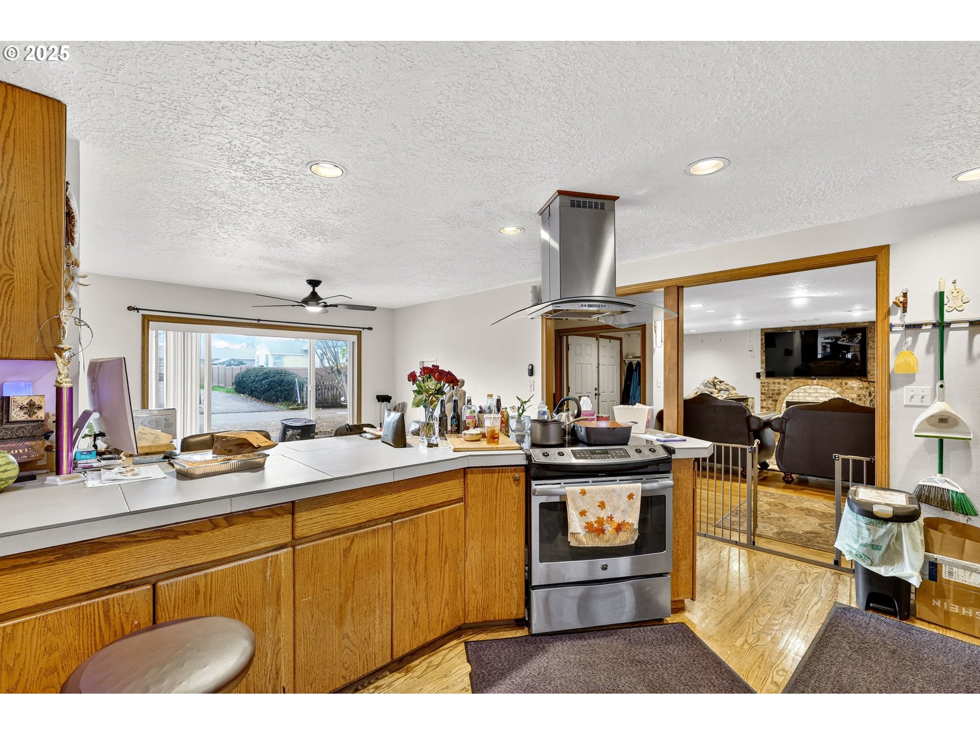8739 Southeast Knapp Street Portland, OR 97266 - Photo 12 of 23 a kitchen with lots of counter top space and living room