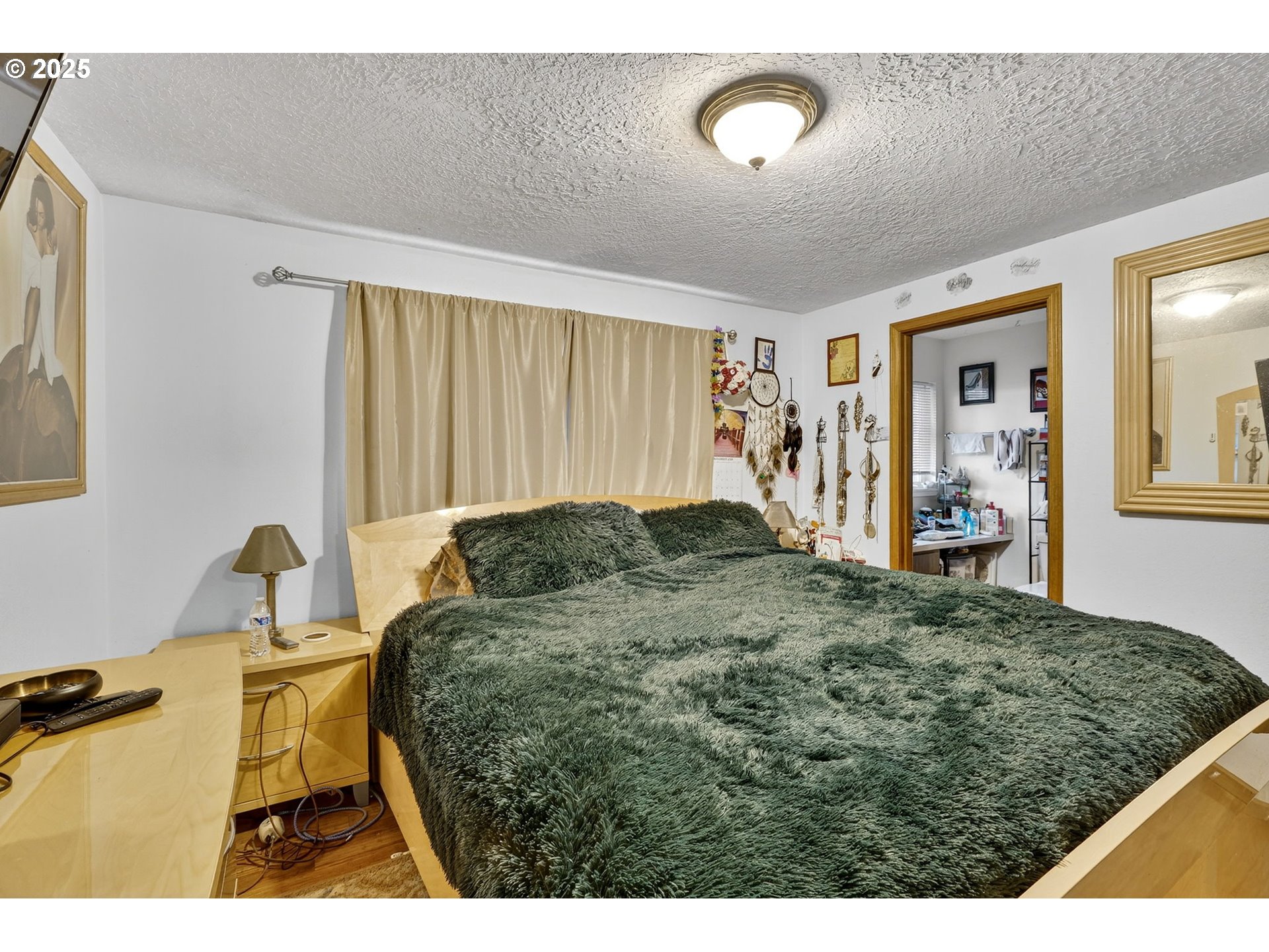 8739 Southeast Knapp Street Portland, OR 97266 - Photo 13 of 23 a living room with a bed furniture and a window