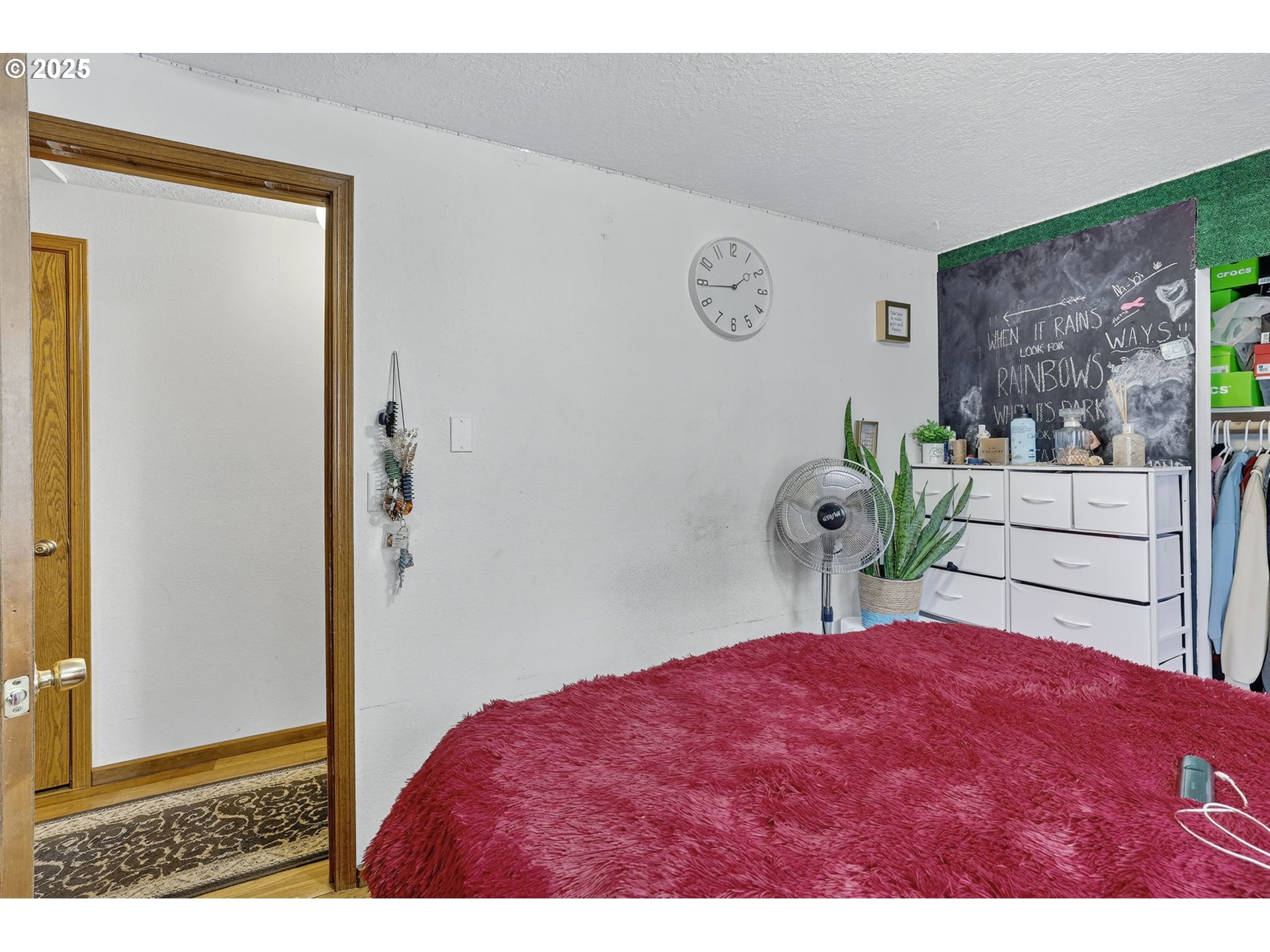 8739 Southeast Knapp Street Portland, OR 97266 - Photo 14 of 23 a bedroom with a bed and a view of kitchen