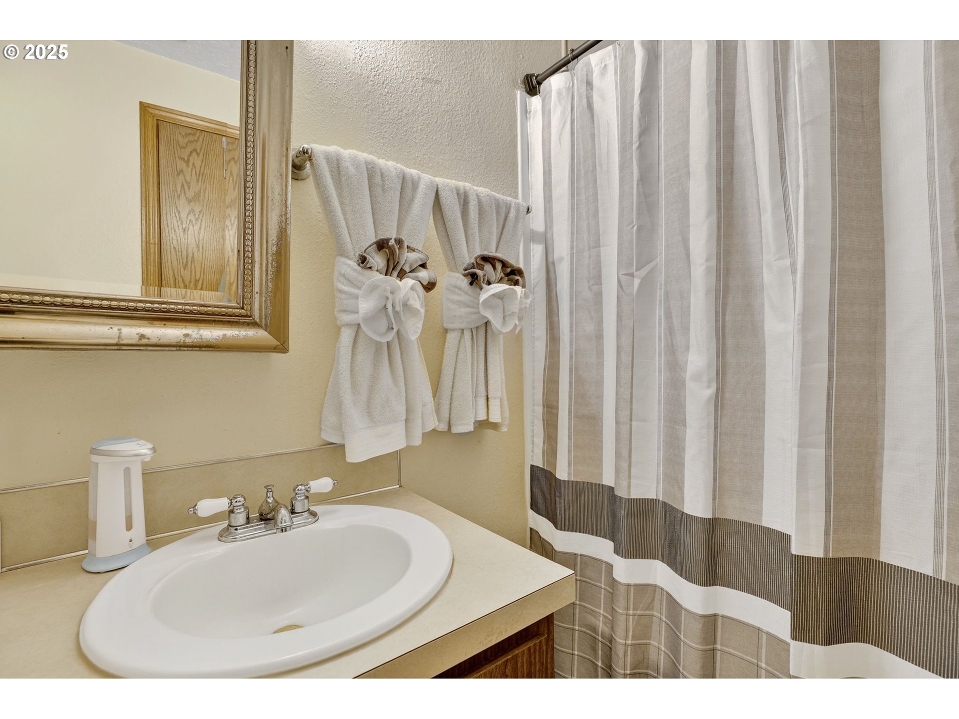 8739 Southeast Knapp Street Portland, OR 97266 - Photo 17 of 23 a bathroom with a sink and a mirror