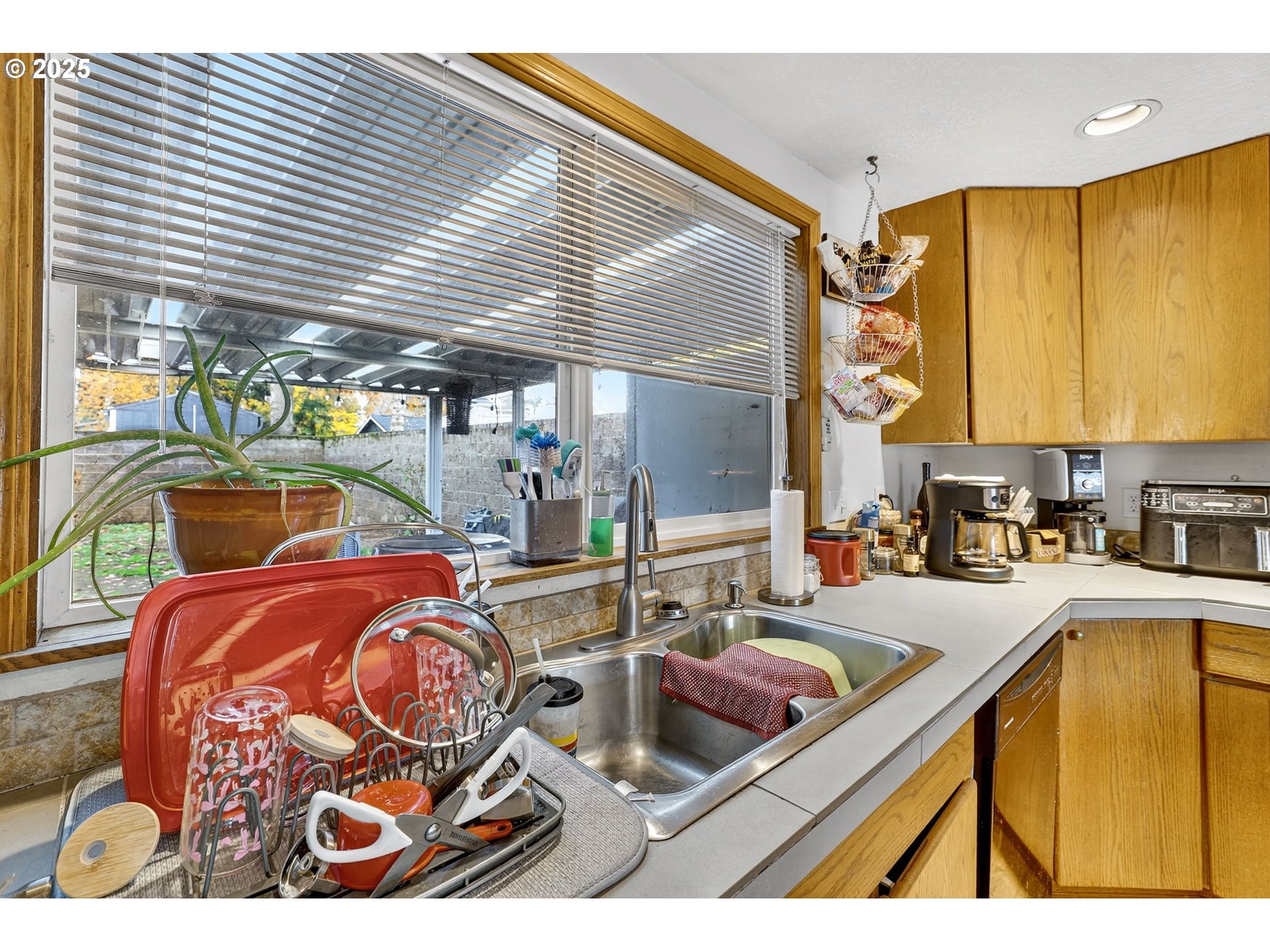 8739 Southeast Knapp Street Portland, OR 97266 - Photo 10 of 23 a kitchen with stainless steel appliances kitchen island granite countertop a sink and cabinets