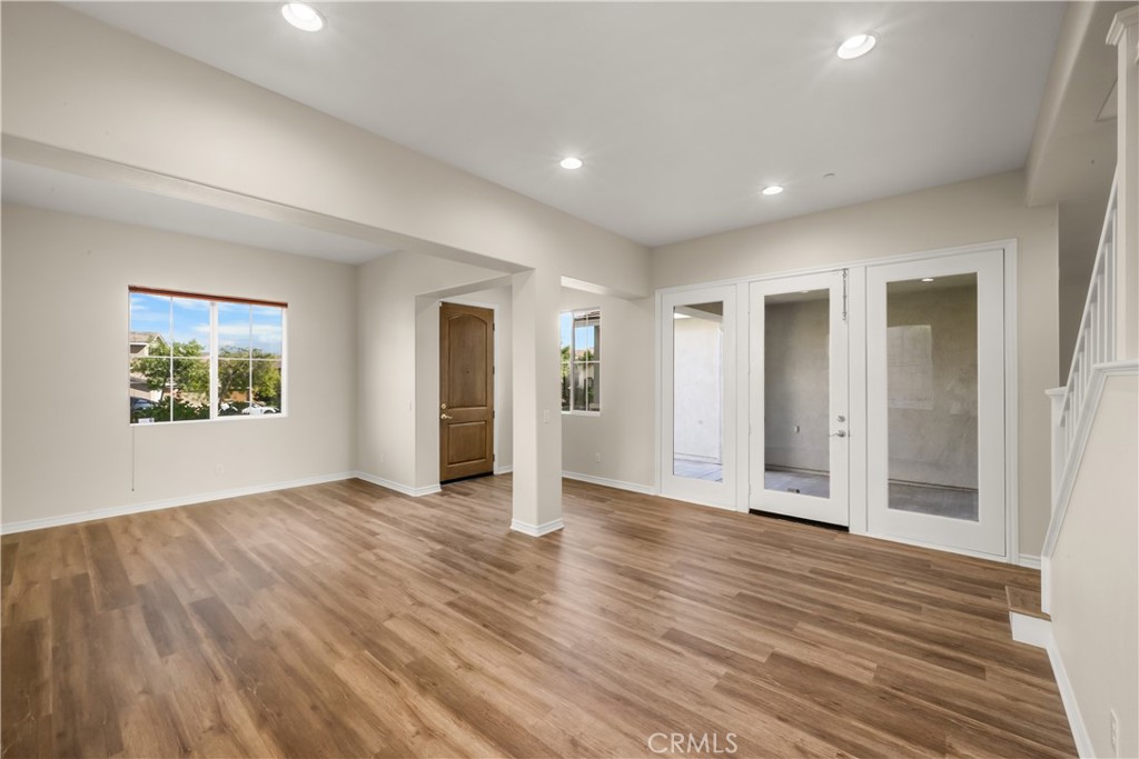 5212 Crimson Place Rancho Cucamonga, CA 91739 - Photo 7 of 62 an empty room with wooden floor and windows