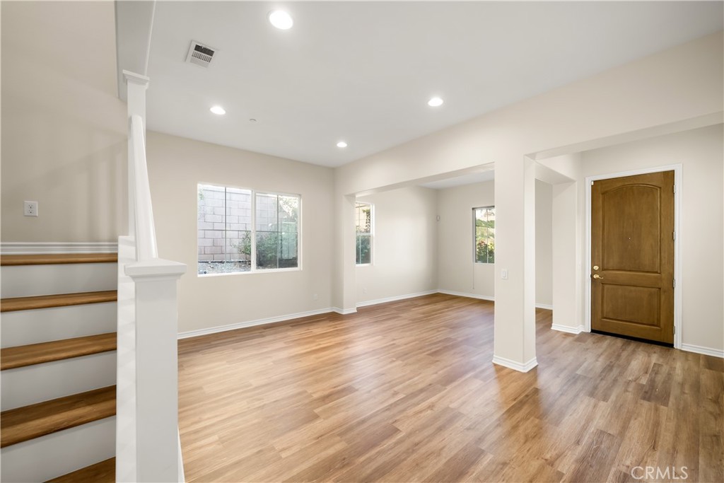 5212 Crimson Place Rancho Cucamonga, CA 91739 - Photo 8 of 62 a view of an empty room with a window and wooden floor