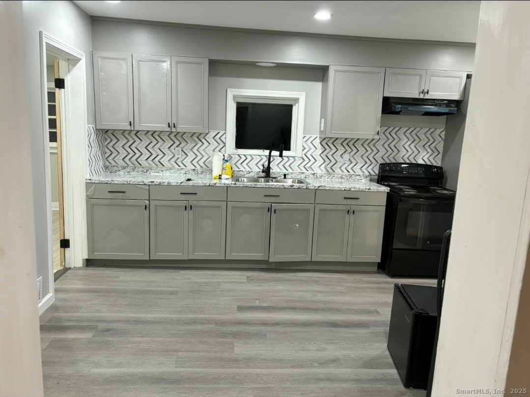 190 Howard Avenue, Unit 1 Ansonia, CT 06401 - Photo 1 of 7 a bathroom with a sink and a mirror