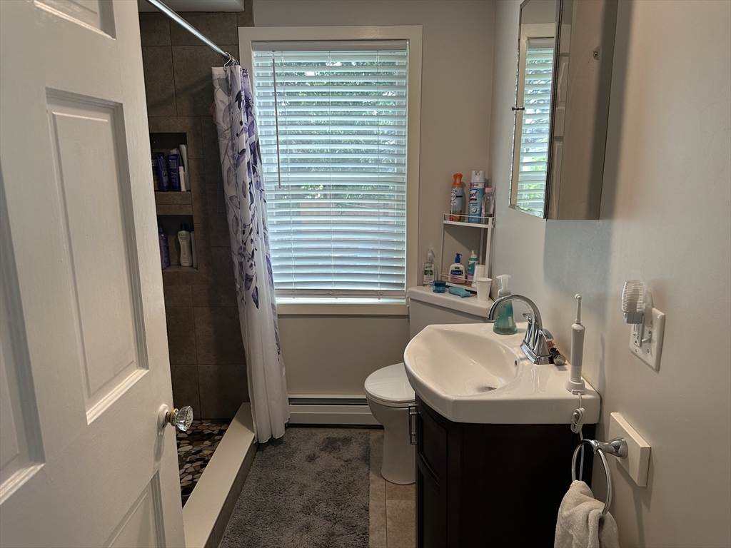 110 Holyoke Street Lynn, MA 01905 - Photo 4 of 13 a bathroom with a sink and a mirror