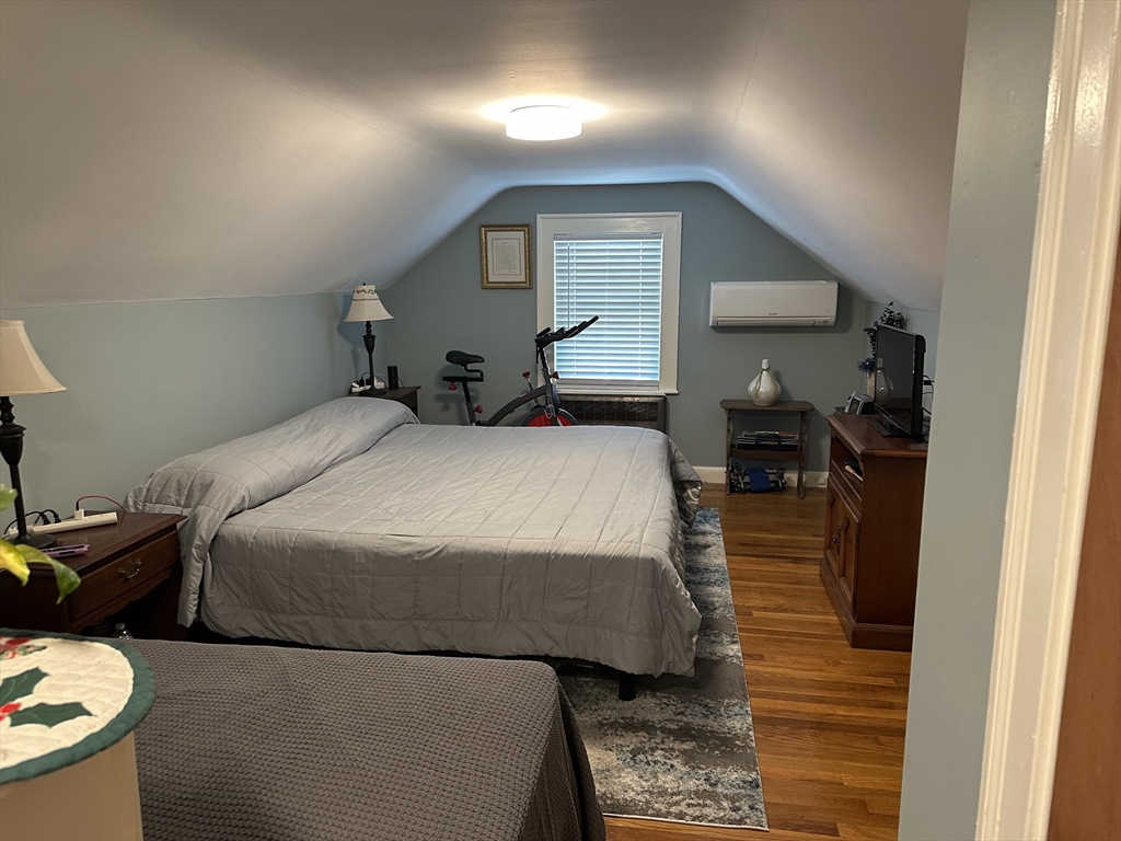 110 Holyoke Street Lynn, MA 01905 - Photo 10 of 13 a bedroom with a bed and a mirror