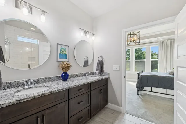 a bathroom with a granite countertop sink a mirror and a large mirror