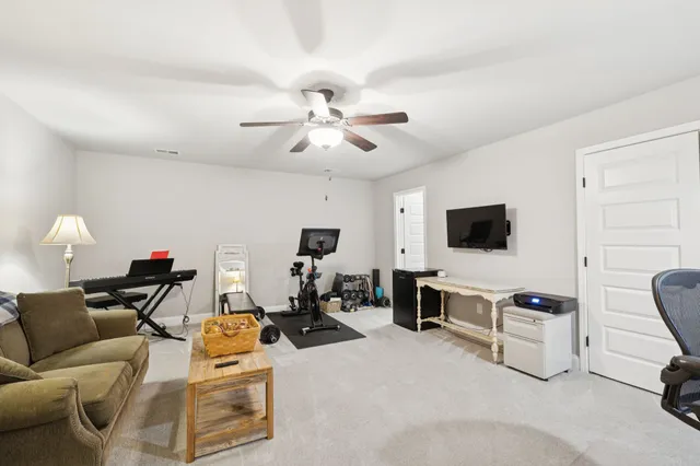 a view of a livingroom with furniture and a flat screen tv