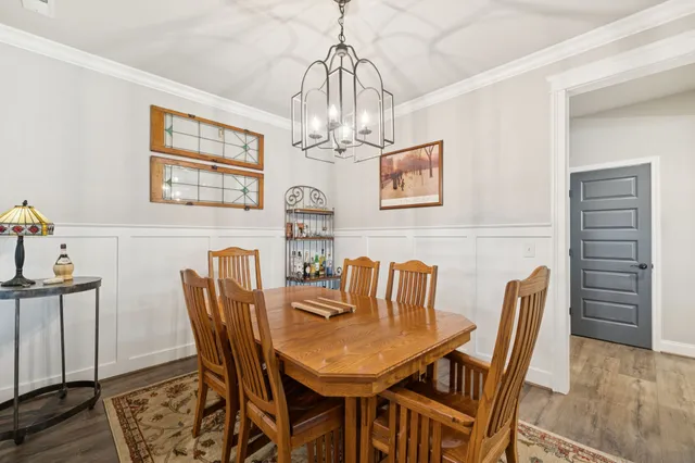 a view of a dining room with furniture wooden floor and a chandelier