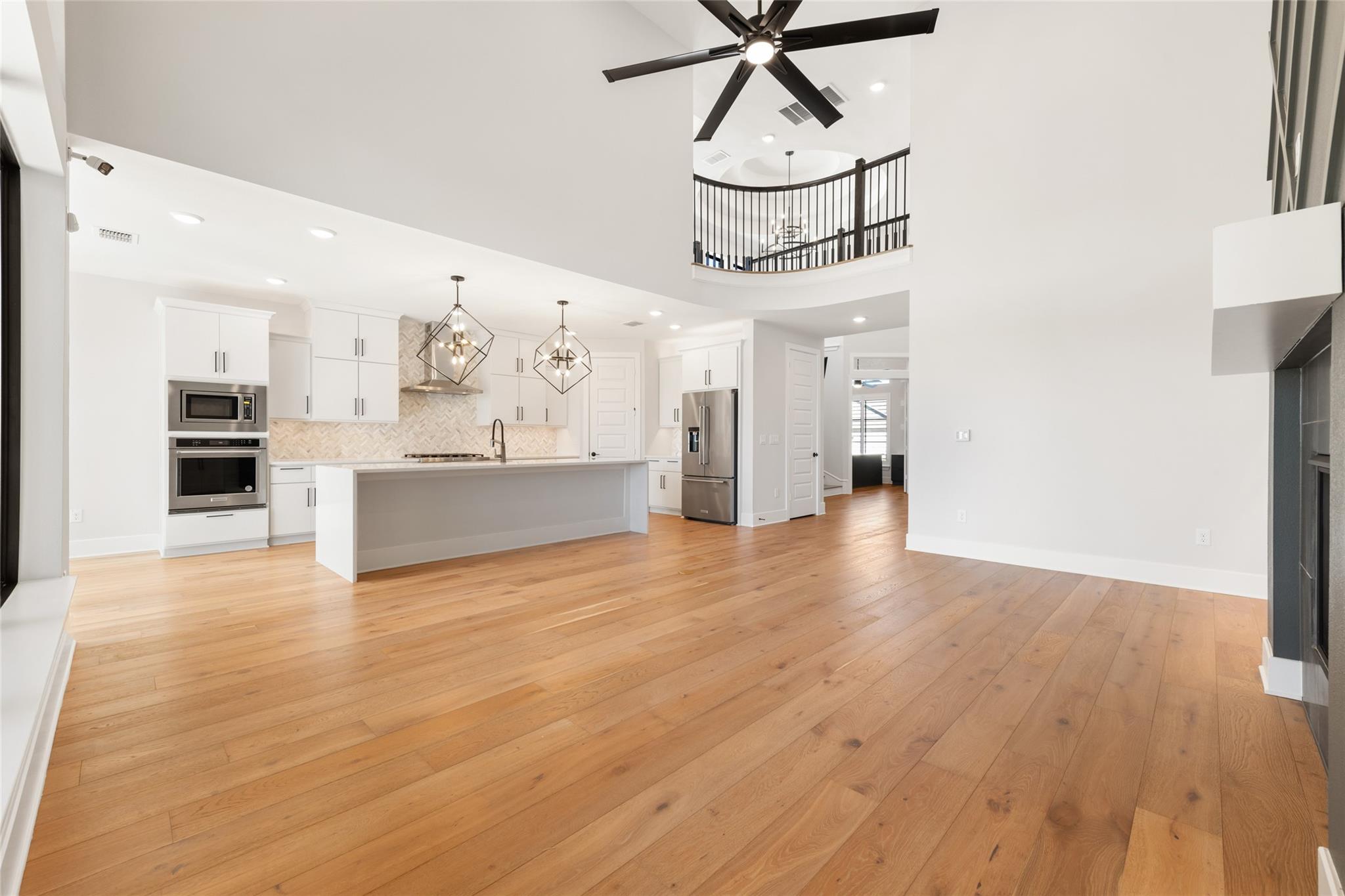 6216 Bower Well Road Austin, TX 78738 - Photo 8 of 31 a view of a livingroom with wooden floor and chandelier