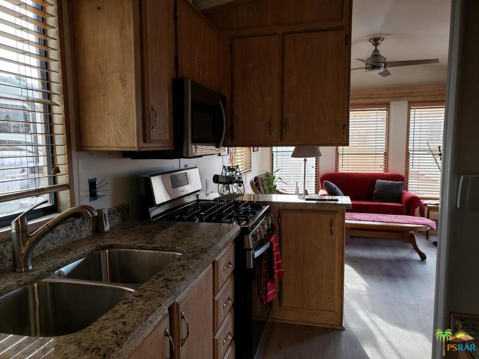 69801 Ramon Road, Unit 192 Cathedral City, CA 92234 - Photo 13 of 14 a kitchen with a sink cabinets and a window