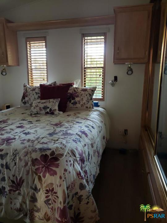 69801 Ramon Road, Unit 192 Cathedral City, CA 92234 - Photo 6 of 14 a bed sitting in a bedroom next to a window