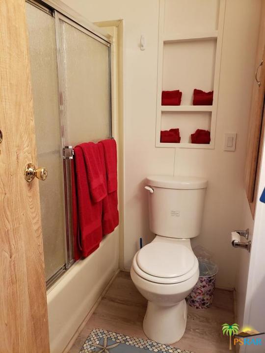 69801 Ramon Road, Unit 192 Cathedral City, CA 92234 - Photo 9 of 14 a bathroom with a toilet and a shower curtain