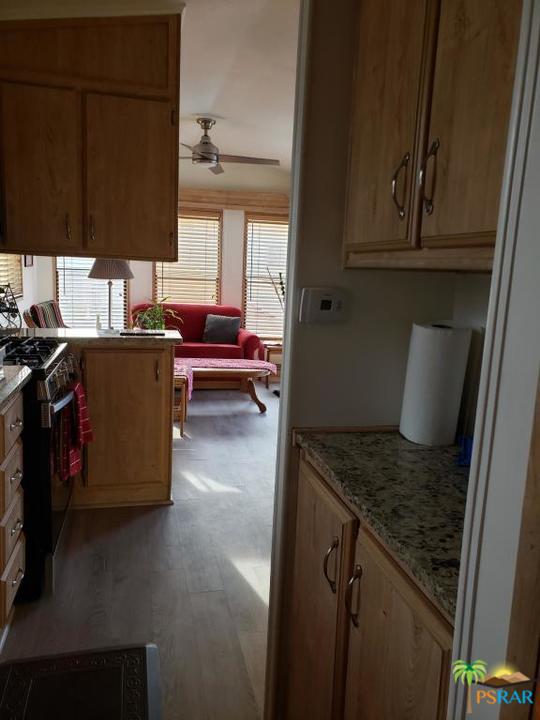 69801 Ramon Road, Unit 192 Cathedral City, CA 92234 - Photo 10 of 14 a kitchen with a stove and a refrigerator