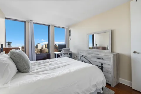 a bedroom with a bed and a dresser