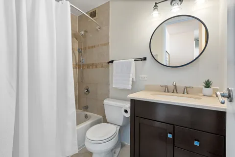 a bathroom with a toilet a sink and a mirror