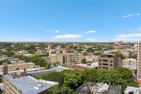an aerial view of residential houses with city view