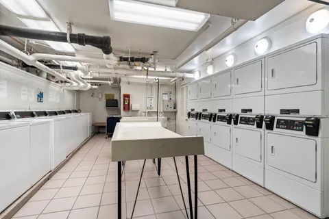 a kitchen with stainless steel appliances kitchen island granite countertop a sink and cabinets