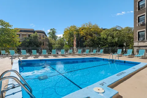 a view of swimming pool with outdoor seating and plants