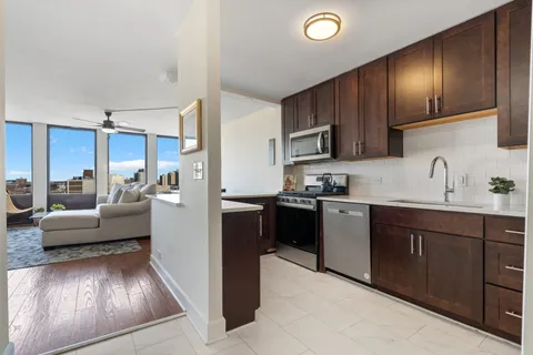 a kitchen with furniture a refrigerator and a sink