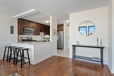 a kitchen with a refrigerator and a stove top oven