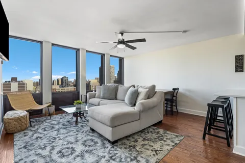 a living room with furniture a rug and a chandelier