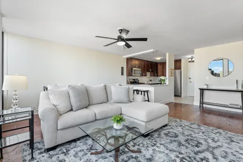 a living room with furniture and kitchen view