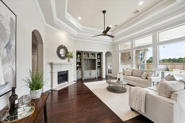 a living room with furniture a large window and a fireplace