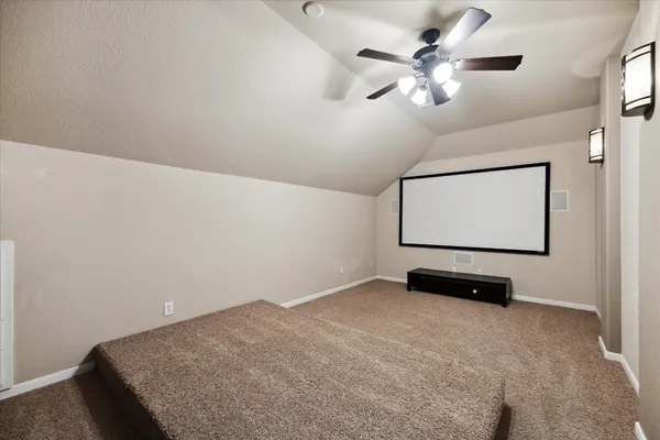 a room with ceiling fan and a wooden floor